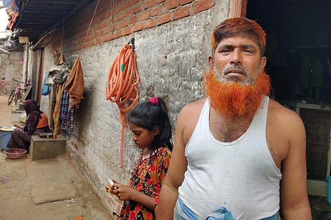 Mohammed Nazir, a refugee in camp-2, standing against his house
