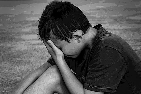 Sad boy in a beach