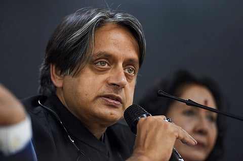 Shashi Tharoor speaking into a mic