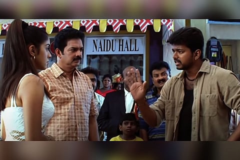 Asin and Vijay in Sivakasi with Asin dressed in a white top and Vijay in a khaki open shirt advising her
