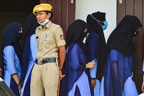 Students in Karnataka wearing hijab walking at a school