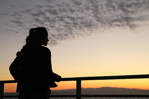 Silhouette of a person staring into the sunset