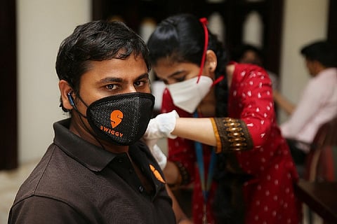 Swiggy delivery personnel getting vaccinated