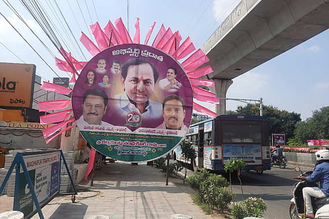 A TRS hoarding featuring KCR on a pavement in Hyderabad amid the party's 20 years celebration
