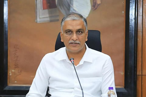 Telangana Finance Minister T Harish Rao speaking into a mic