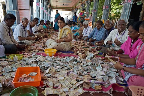 Members of Sri Kabaleeswarar Temple Trust in Chennai counting the funds deposited in Hundi by devotees following the demonetisation of Rs 500 and Rs 1000 notes in November 2016