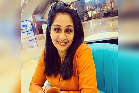 Tessa Joseph is seen wearing a yellow top in the image