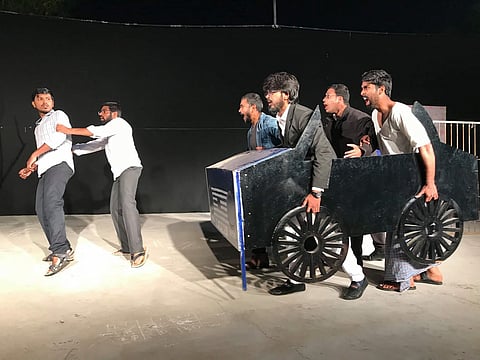 Theatre artists performing a play with props