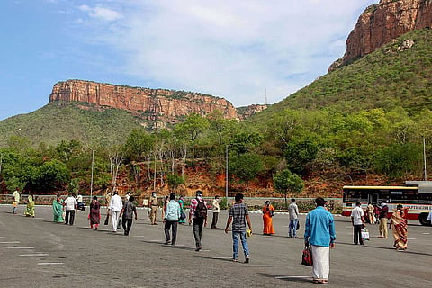 Employees queue to board a bus at foothill of Lord Venkateswara temple at Tirumala