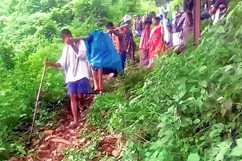 Tribals carrying an ailing patient in a doli