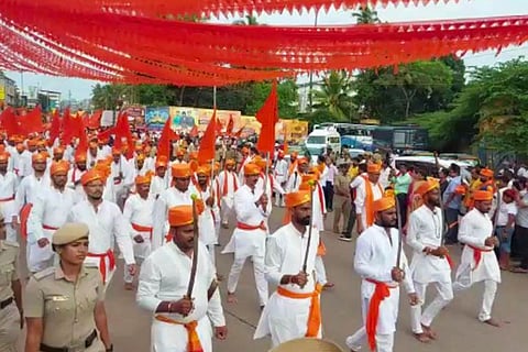 Hindu Jagarana Vedike march in Udupi, men wearing white kurtas and saffron turbans are marching holding flags and swords
