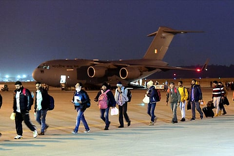 A line of Indian students walking from their flight after landing in India from Ukraine