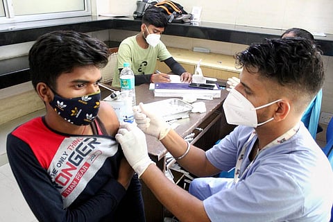 Representative image of a man taking COVID-19 vaccine
