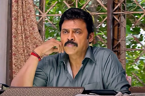 Venkatesh in a blue grey shirt looking worried in Drushyam