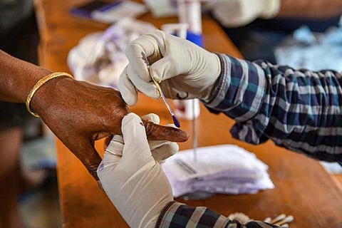 Ink being applied to a voters hand after polling