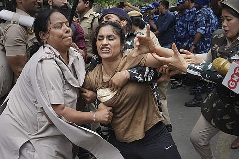 Protesting wrestlers being manhandled by police