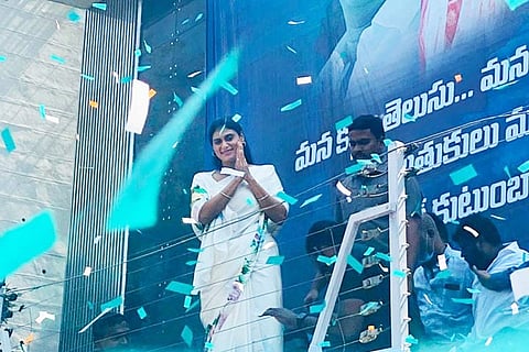 YS Sharmila in a white saree, greeting her supporters gathered outside her residence