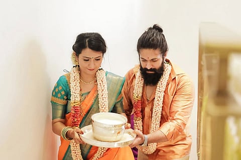 Actors Yash and Radhika Pandit in traditional attire at their housewarming ceremony