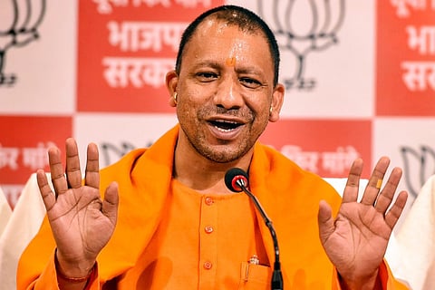 Uttar Pradesh CM Yogi Adityanath speaking into a mic