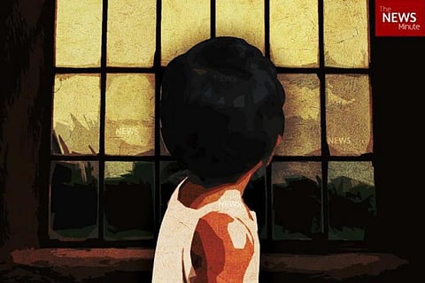 picture of child looking out the window
