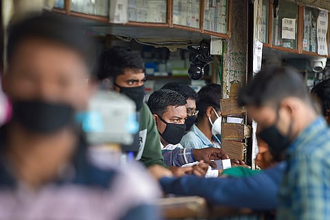 Men at chemist shop wearing masks