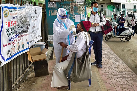 Health worker collecting sample for COVID-19 test