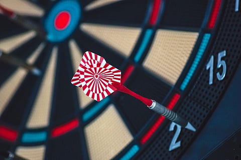 Why the dartboard looks like it does, and how bad players can do better