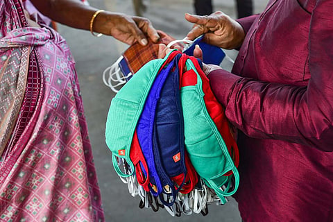 A vendor selling face masks: Masks now optional in Telangana except for those over 60: Health official