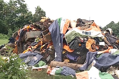 Screen grab of a video that shows national flags dumped in a waste heap