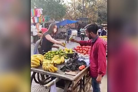 Customer buying from. fruitseller