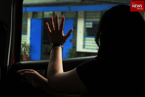 Representative image of a woman inside a cab with her hand on the window