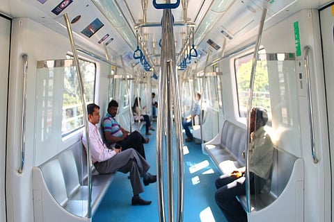 Passengers sitting inside a Bengaluru metro train