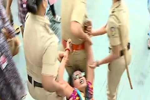 Kunjila Mascillamani being removed from the venue of Women's International Film Festival in Kozhikode