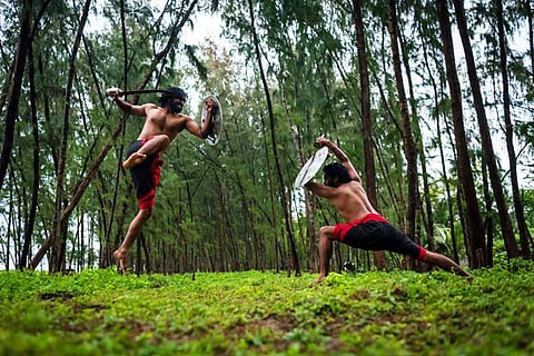 Two Kalaripayattu artists performing outdoors
