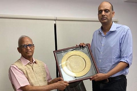 The winner trophy being presented to Rajeev Nannapaneni