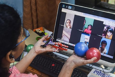 A girl student attending online class on a laptop