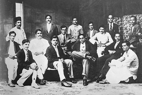 Ambedkar (centre, crossed leg) with members of the Samaj Samata Sangh, founded with his Savarna associates in September 1927. In this photograph of 9 June 1929, sitting left to right are M.B. Deshmukh, Bhalchandra V. Pradhan, Devrao V. Naik, A.S. Asaikar, M.G. Pradhan, Ambedkar, D.V. Pradhan, S.S. Gupte and G.R. Pradhan. Standing: G.A. Jadhav, R.D. Kawali, N.V. Khandke, P.K. Kangle, Bhaskarrao Kadrekar and V.A. Kadam.