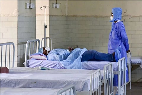 A patient sleeping on a hospital bed.