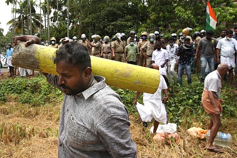 Man carrying survey stone in Chottanikkara