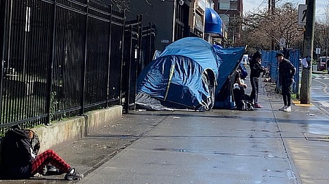 Pandora Street, Victoria B.C., March 15, 2025, a daily scene with tents set up near the major shelter and food service. A series of transactions like this one can be seen. Victoria officials have conducted multiple sweeps on the street, and millions are spent to displace and clean up encampments in city parks.