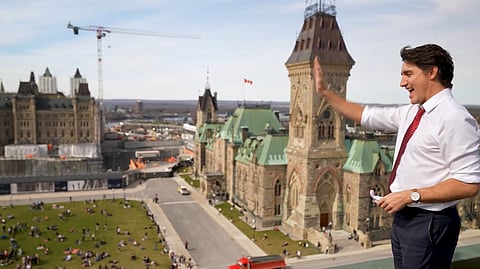 Trudeau stands atop a parliamentary building