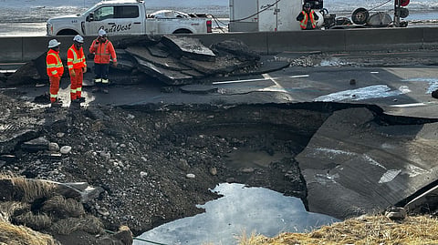 Construction workers at the asses water main break in northwest Calgary