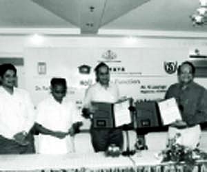 Indira Gandhi National Open University (IGNOU) director V.N.Rajasekharan Pillai and IT Secretary Ajayakumar exchanging MoU signed by IGNOU