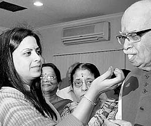 BJP leader L K Advani being offered sweets by his daughter Pratibha Advani on his birthday in New Delhi on Saturday.