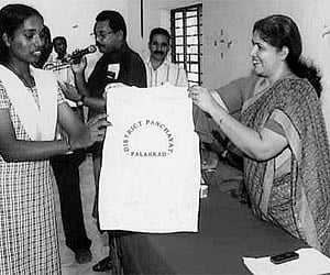 Palakkad panchayat president Subaida Ishaaq handing over jerseys to the students who were selected for the School Sports and Games Meet to be held in
