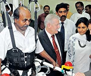 L Sashi (L), a patient, using the Lokomat at the Apollo Hospital in the city on Monday. Also seen are Gery Colombo, CEO of Hocoma and MD of Apollo Hos