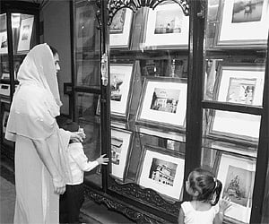 A Sikh woman and her children go around a photo exhibition showcasing 300 years of Gurta Gaddi of Sri Guru Granth Sahebji organised at the Salar Jung