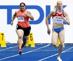 Savannah Sanitoa, and Russia's Anna Geflikh, compete in 100m first round heat during the World Athletics Championships in Berlin on Sunday. (AP)
