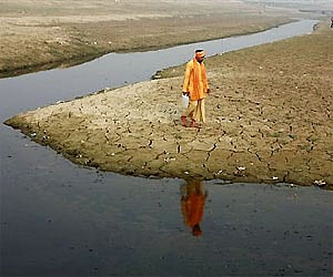A  Hindu holy man, carries a can filled with water from the Ganges River in Allahabad. AP Photo
