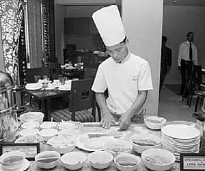 A cook prepares a Chinese dish during opening of restaurant `Mainland China' in hotel The Crown on Sunday